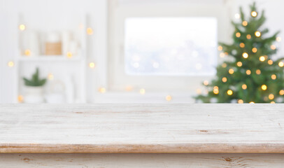 Table space in front of defocused window sill with christmas tree