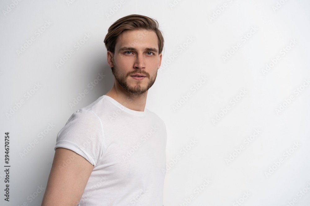 Portrait of a smart young man standing against white background. Portrait of a smart young man standing against white background.