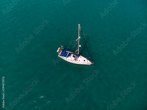 Bild auf Leinwand Aerial wonderful view of a enormous white and blue yacht sailing across the blue