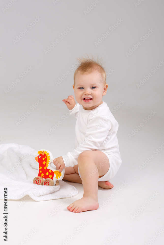 baby playing with a colorful toy isolated on a white background baby playing with a colorful toy isolated on a white background