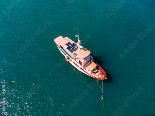 Aerial wonderful top view of a colorful interesting sail boat staying at the sea © Semachkovsky 