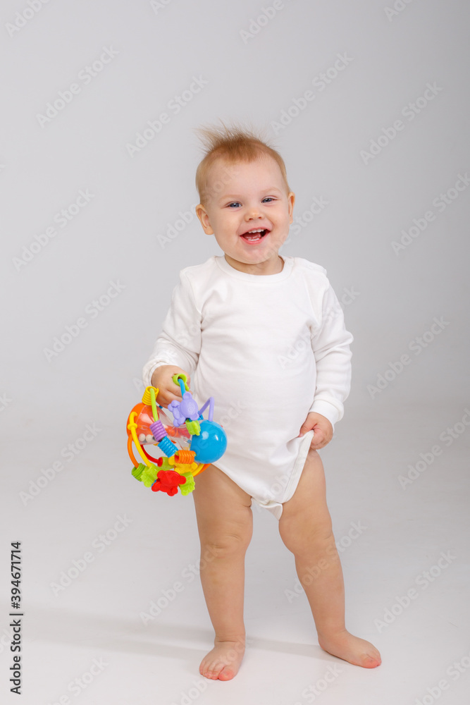 baby playing with a colorful toy isolated on a white background baby playing with a colorful toy isolated on a white background