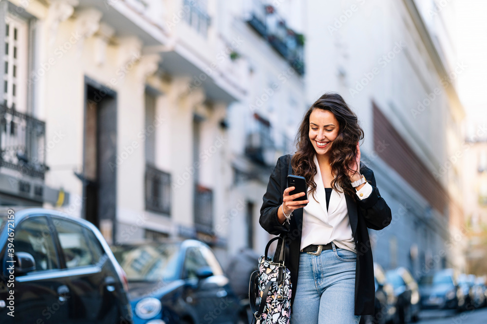 Beautiful woman using a mobile in the street. Communication concept