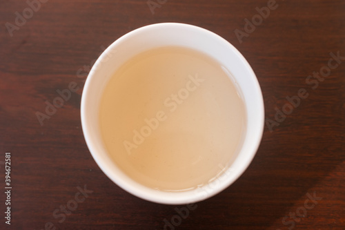 Beautiful porcelain tea cup close up shot. Hydrating pale liquor in it.
Bai Hao Yin Zhen (White Hair Silver Needle) white tea from Fujian province. Top view.