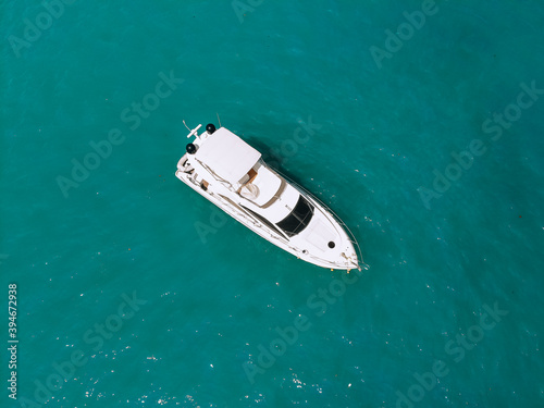 Adorable aerial top view photo of a laxury huge two-storey yach sailing across the deep blue sea © Semachkovsky 
