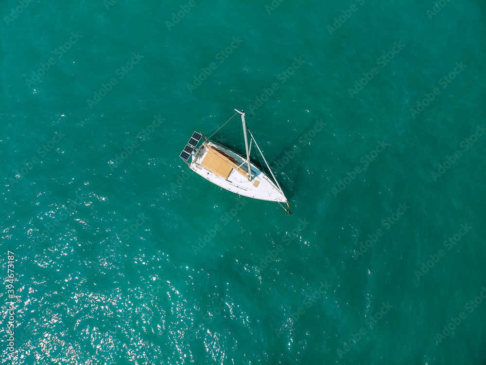Picturesque top view of a huge white yacht sailing across the deep sea. Aerial view. Picturesque top view of a huge white yacht sailing across the deep sea. Aerial view.