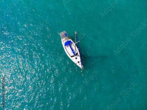 Bild auf Leinwand Aerial wonderful view of a enormous white and blue yacht sailing across the blue