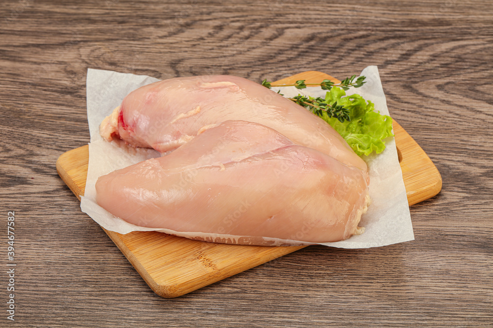 Raw chicken breast over board Raw chicken breast over board
