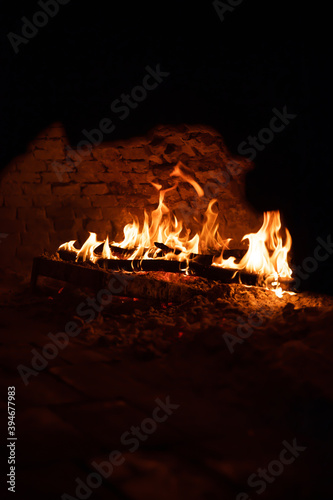 Fire flames in the stone oven or fireplace on black background