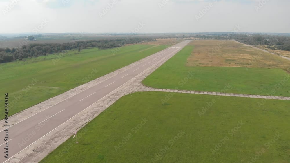 Small private jet airplane with spinning propeller stand on landing strip of secondary airport. Small privately owned plane ready to take off into sky Small private jet airplane with spinning propeller stand on landing strip of secondary airport. Small privately owned plane ready to take off into sky