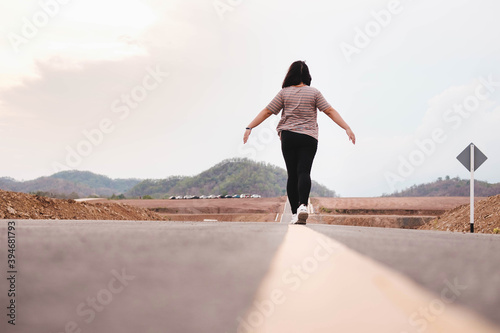 happy young woman enjoying freedom with open hands on street