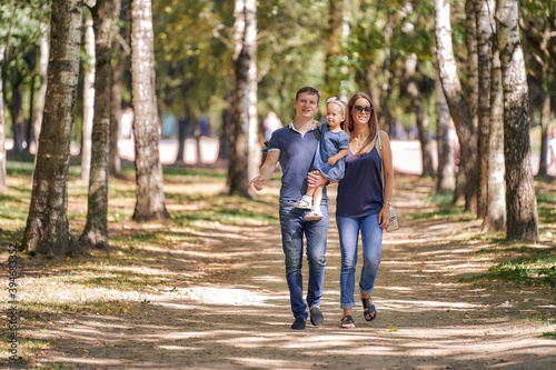 Happy family walk in the park. Weekend together nature. © Aleksandr