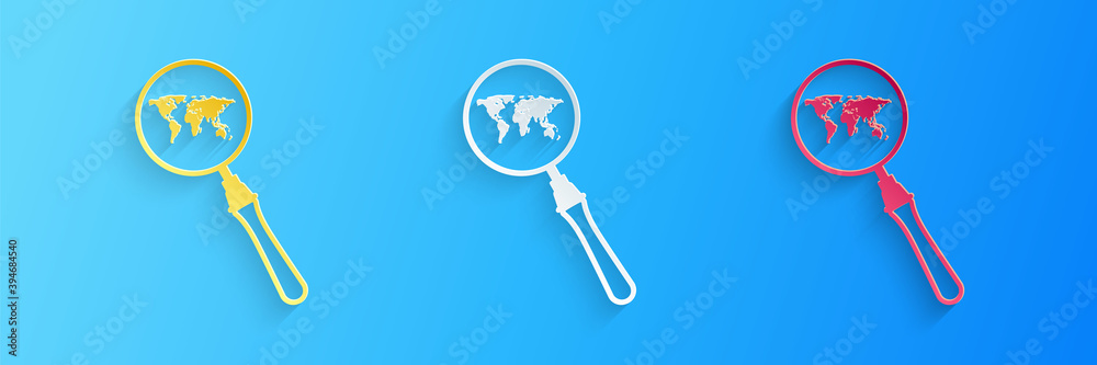 Paper cut Magnifying glass with world map icon isolated on blue background. Analyzing the world. Global search sign. Paper art style. Vector.