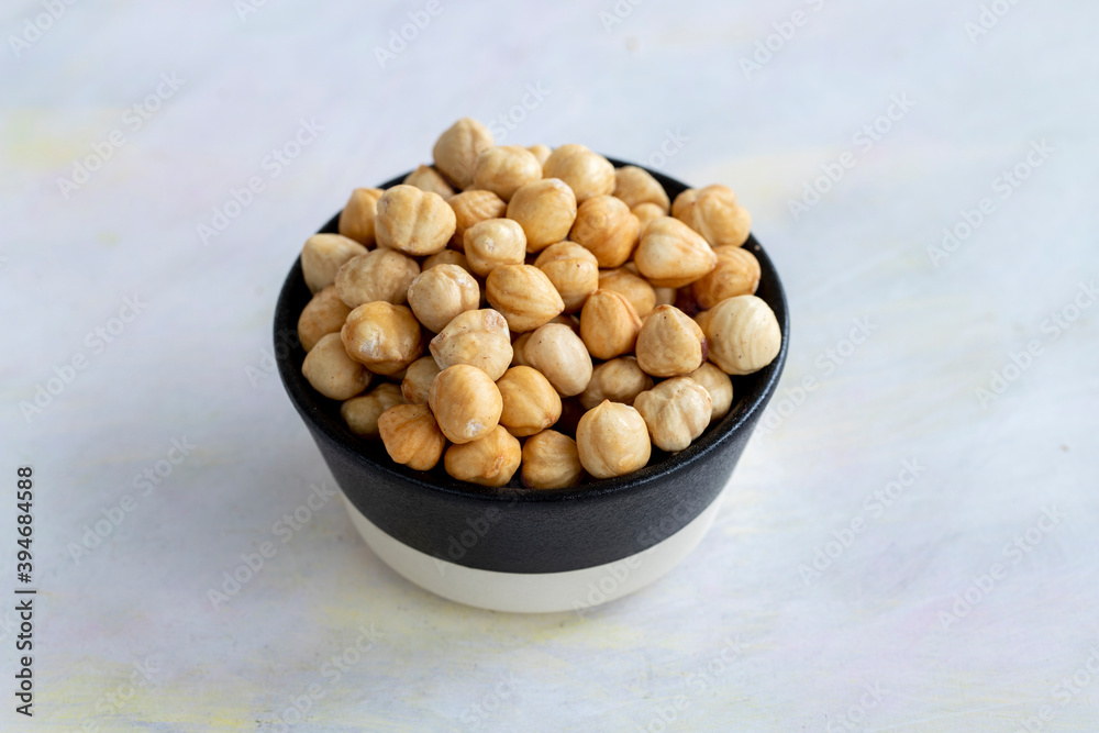 Hazelnuts in plate on white background Hazelnuts in plate on white background