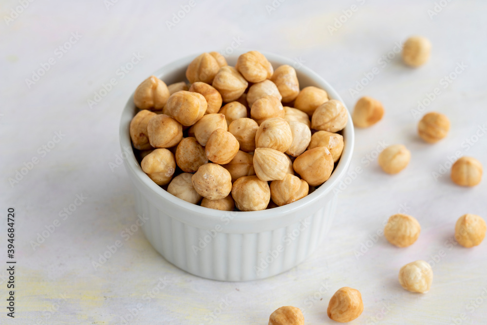 Hazelnuts in plate on white background Hazelnuts in plate on white background