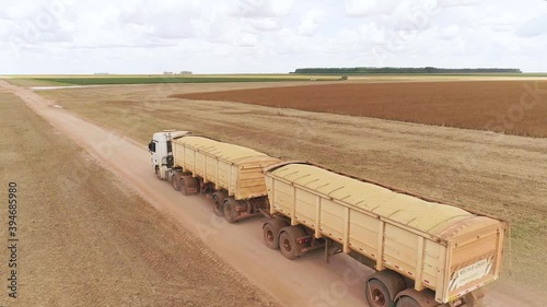 Agribusiness - Aerial image of a truck transporting soybeans, a truck loaded with grain. Harvest being transported to the silo - Agriculture