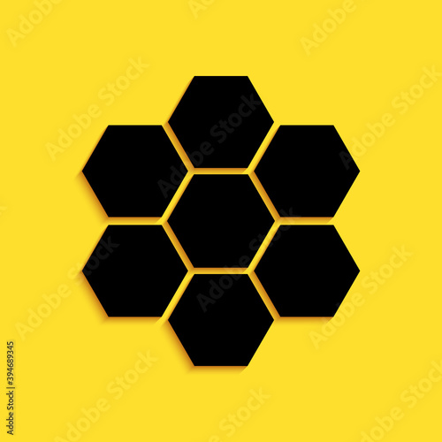 Black Honeycomb sign icon isolated on yellow background. Honey cells symbol. Sweet natural food. Long shadow style. Vector.