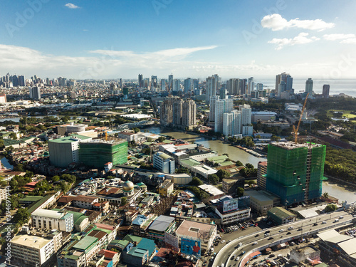 Manila, Philippines -The Pasig river cuts through the sprawling megacity. Distant skylines of Makati and Southern Manila in the background. photo