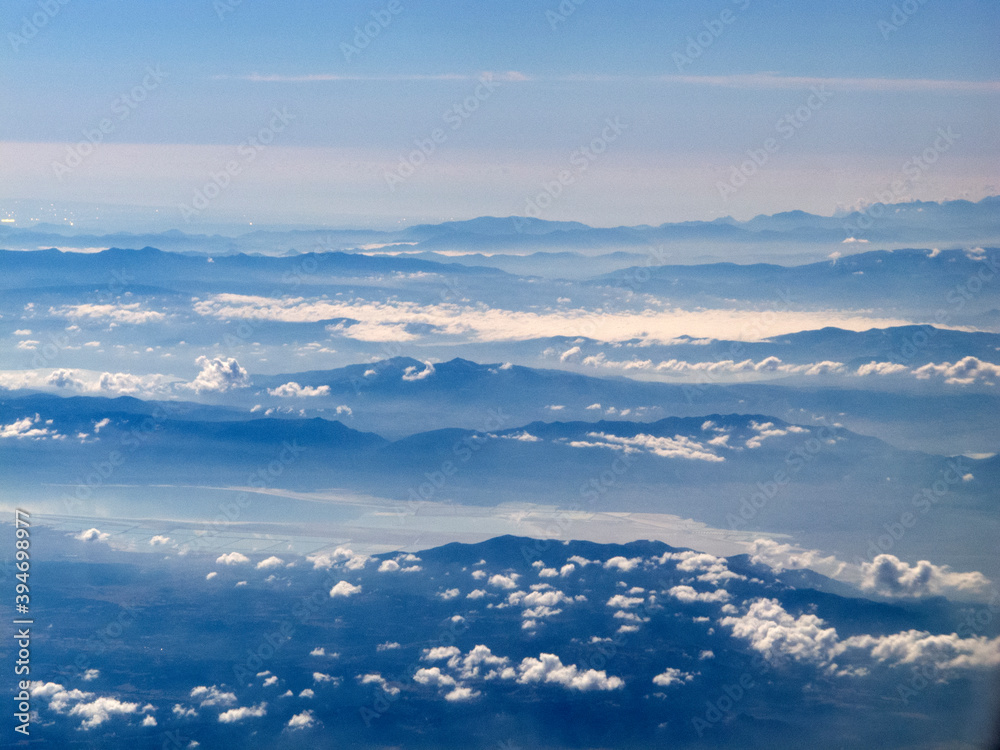 view from the airplane window of the mountains and clouds. view from the airplane window of the mountains and clouds.