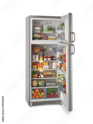 refrigerator with open freezer full of various food