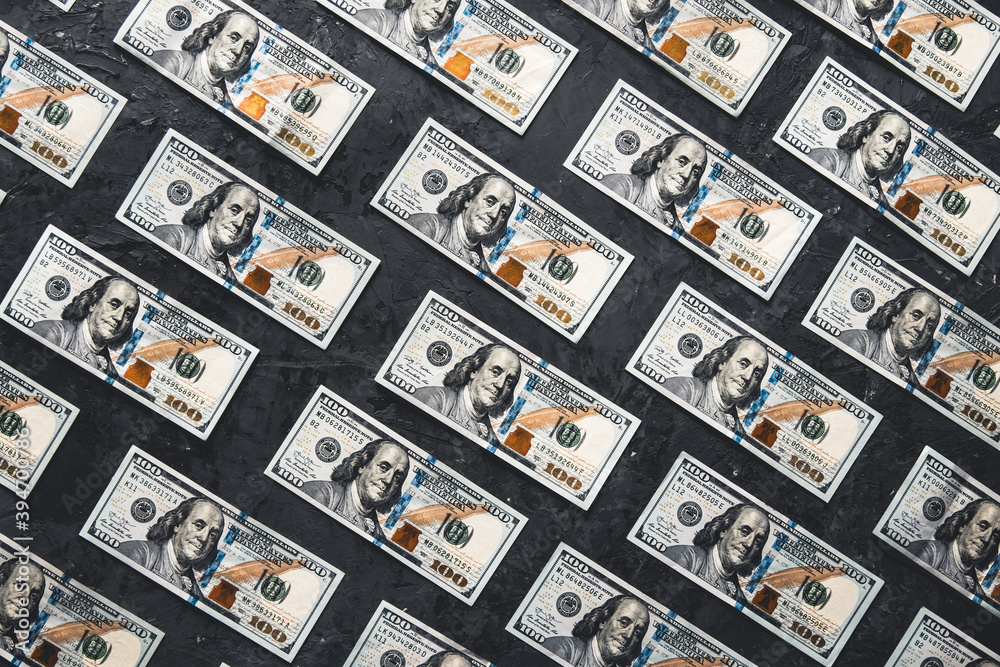 Obraz premium One hundred dollar bills are creatively laid out. Business concept, development perspective.