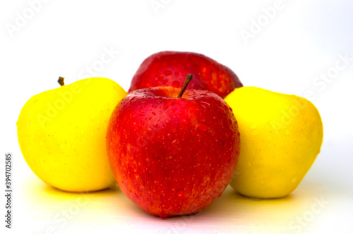 Apples on a white background with water droplets.