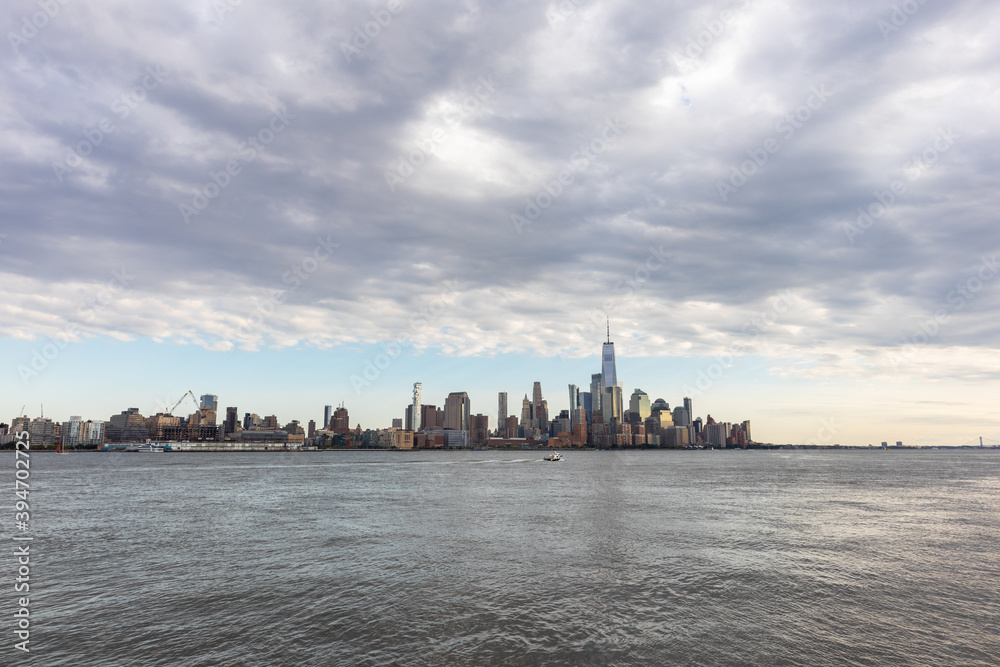 Lower Manhattan Skyline along the Hudson River in New York City with Beautiful Clouds