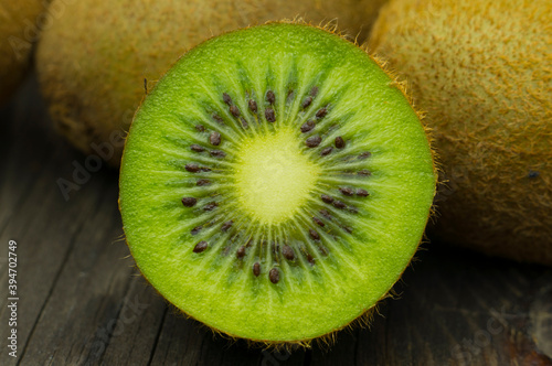 Macro photo of kiwi. Sliced kiwi on a wooden table.