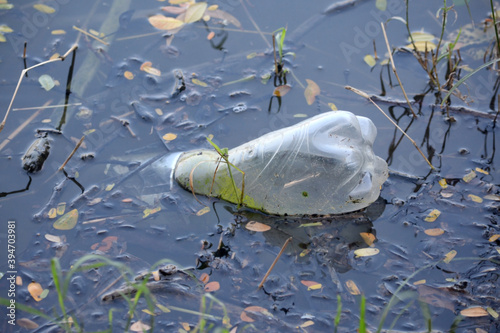   Plastic bottle floating in the water of a lake.
