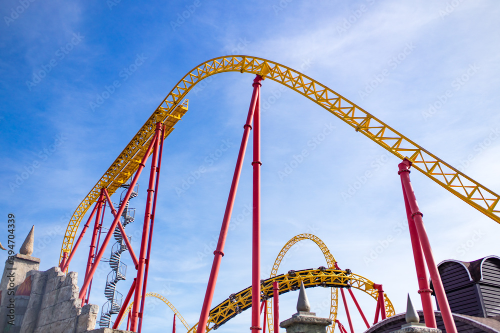 summer blurred photo of Rollercoaster against blue sky summer blurred photo of Rollercoaster against blue sky