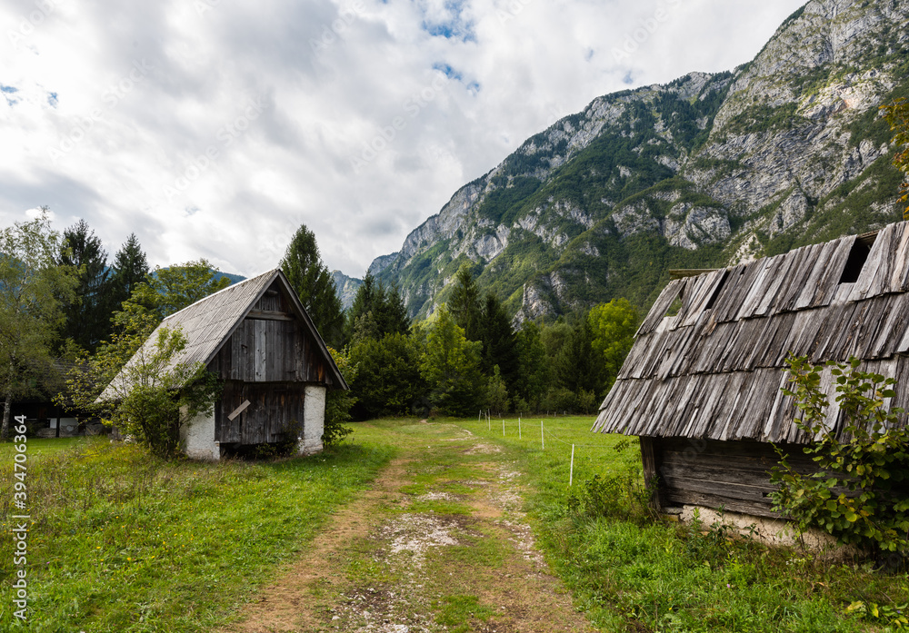 Mountain cabins in the region of Ukanc near the Lake Bohinj in the Triglav National Park in Slovenia on summer day with clouds