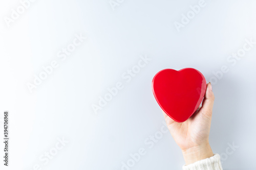 hands holding red heart. - health care, love, organ donation, mindfulness, wellbeing, concept. - world heart day, world health day, National Organ Donor Day.