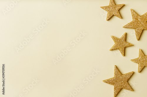 Fortuna gold color background trend of the year 2021. Christmas and New Year background with gold stars. Copy space.