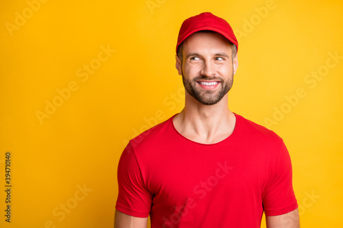 Photo of positive young guy white shiny smile look empty space wear red t-shirt cap isolated yellow color background