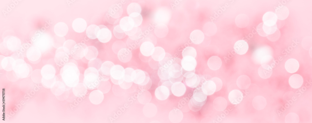 Long wide banner with beautiful white bokeh lights on pink background.  Abstract background for your party.