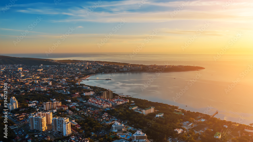 Aerial view of city and sea at sunset, travel and vacation background.