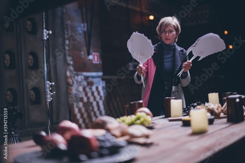 The production designer prepares the scenery on the set.