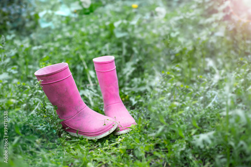 pink rubber boots on the grass