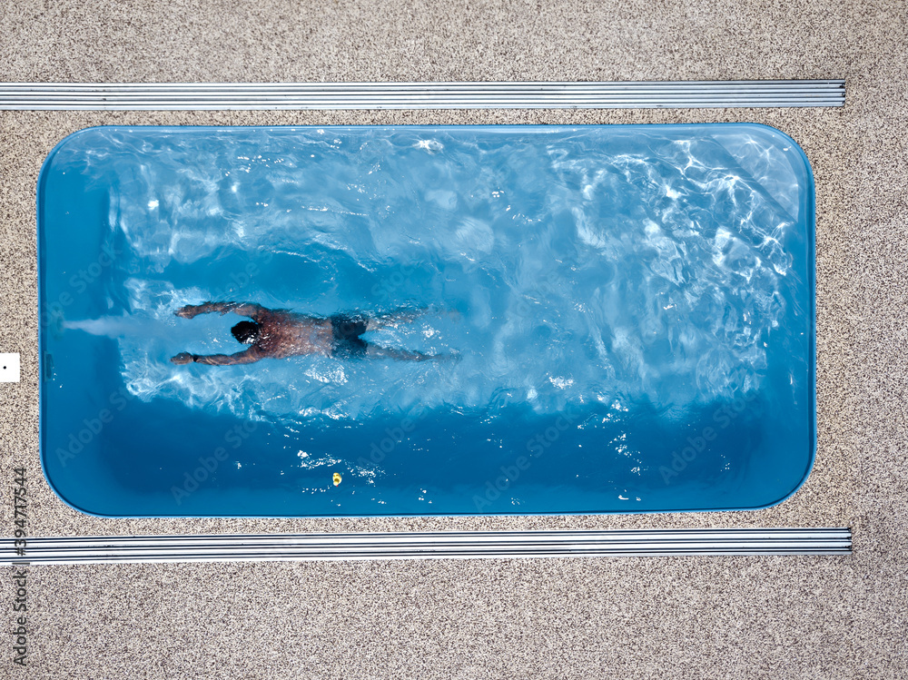 A young man enjoys summer fun by the hotel pool.