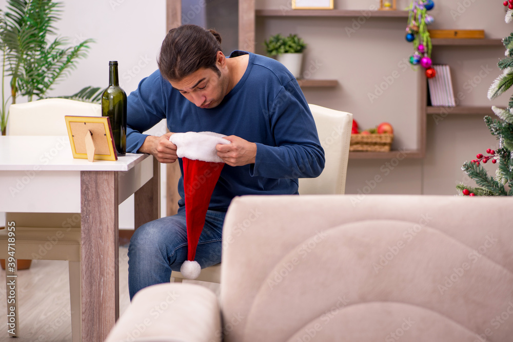 Young man celebrating Christmas alone at home Young man celebrating Christmas alone at home