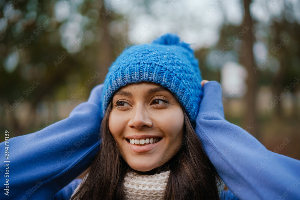 Beautiful happy woman smiling while strolling in autumn forest Beautiful happy woman smiling while strolling in autumn forest