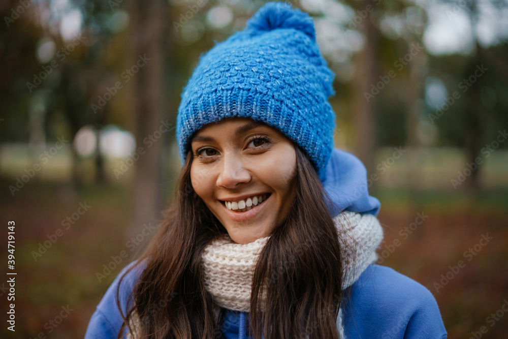 Beautiful happy woman smiling while strolling in autumn forest Beautiful happy woman smiling while strolling in autumn forest