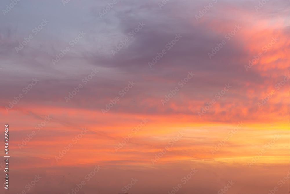 Beautiful sunset sky with orange and pink clouds. Natural background