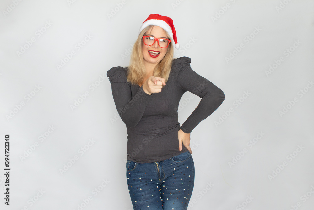 Woman in santa hat and red glasses posing isolated on white background Woman in santa hat and red glasses posing isolated on white background