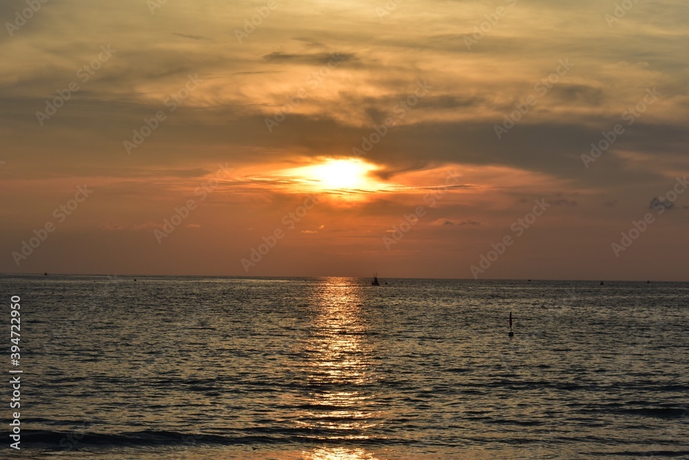 beautiful sunset background with orange shade and  the reflection ,wave .The immense horizon line of  the sea at phuket  thailand