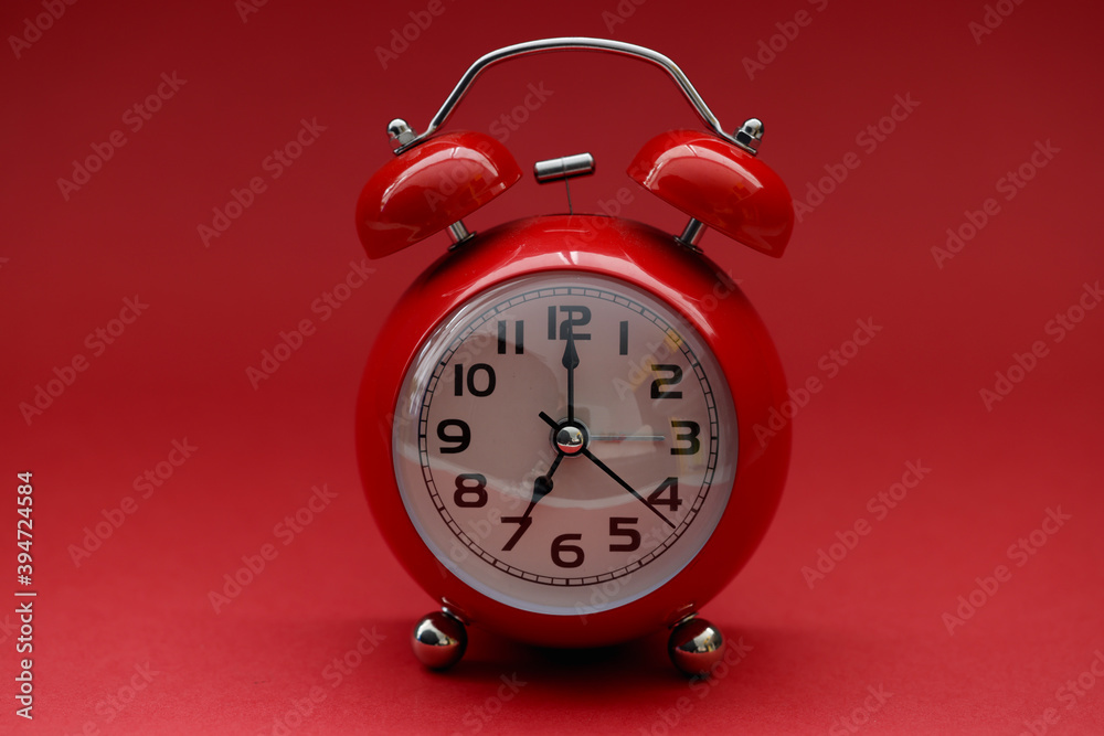 Red alarm clock on a red background. Morning energy boost and awakening concept Red alarm clock on a red background. Morning energy boost and awakening concept