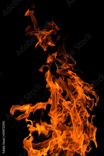 Bright orange red Fire flame against black background, abstract texture