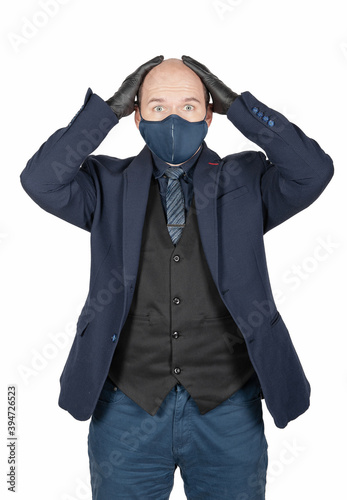 Surprised or scared business man with surgical medical virus protection mask and black gloves isolated.