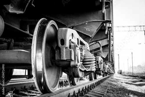 Close-up of a train wheel. Black and white photo with grainy effec