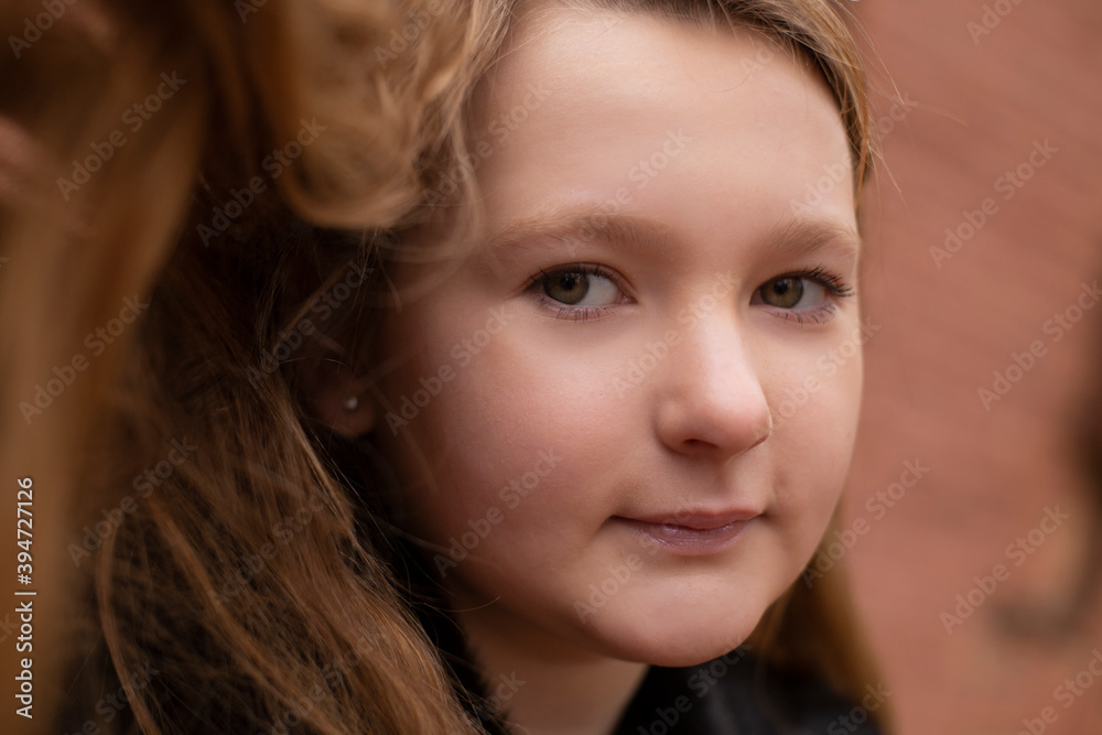 portrait of cute brunette teen girl in black fur coat on the background of brown brick wall . Cosiness, fashion, style portrait of cute brunette teen girl in black fur coat on the background of brown brick wall . Cosiness, fashion, style